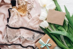 woman-lingerie-jewelry-and-perfume-on-soft-fabric-and-tulips.jpg